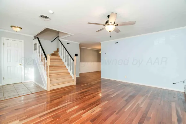 a view of an entryway with wooden floor and cabinet