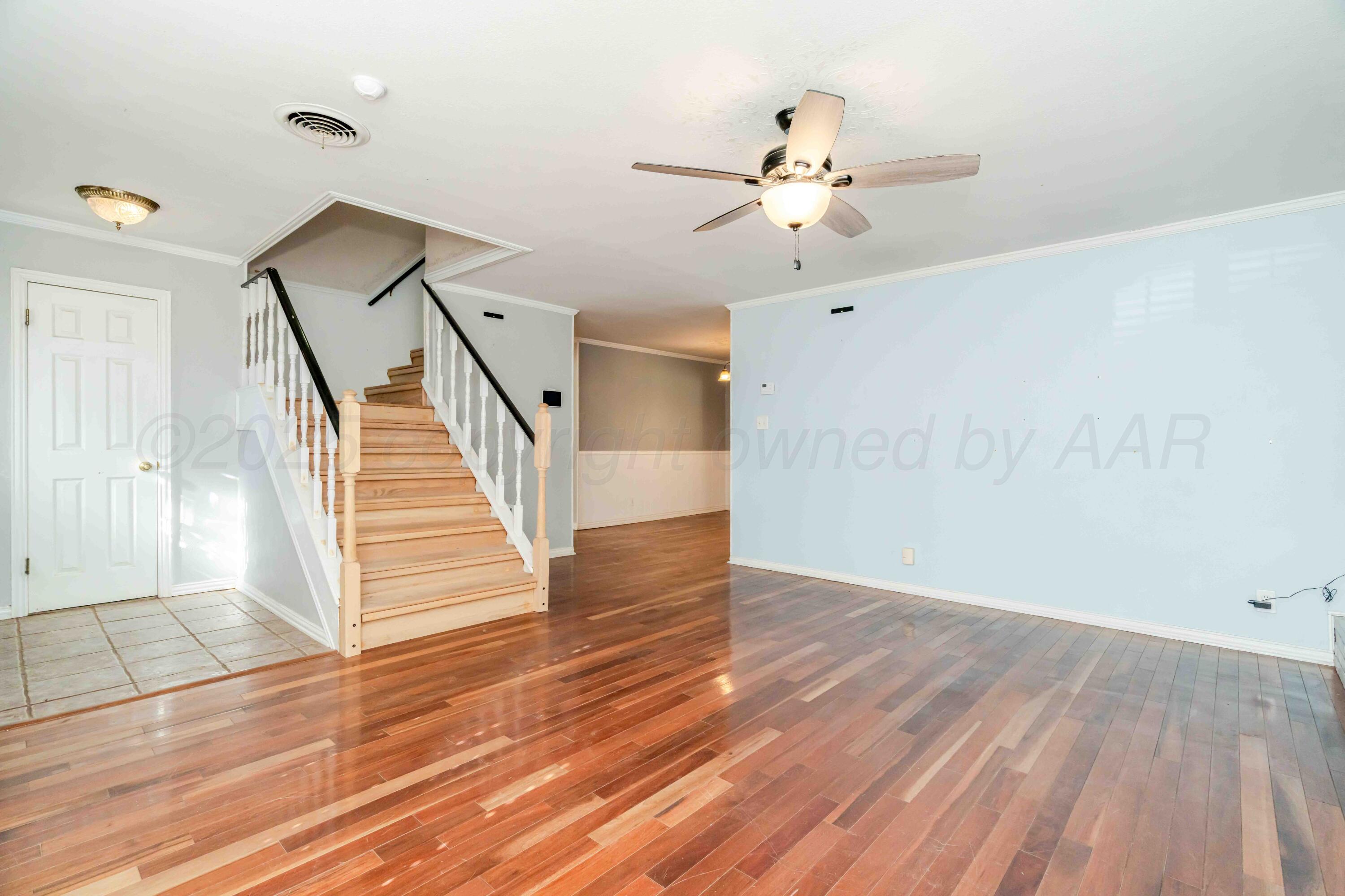 39 Crockett Drive Tulia, TX 79088 - Photo 7 of 29 a view of an entryway with wooden floor and cabinet