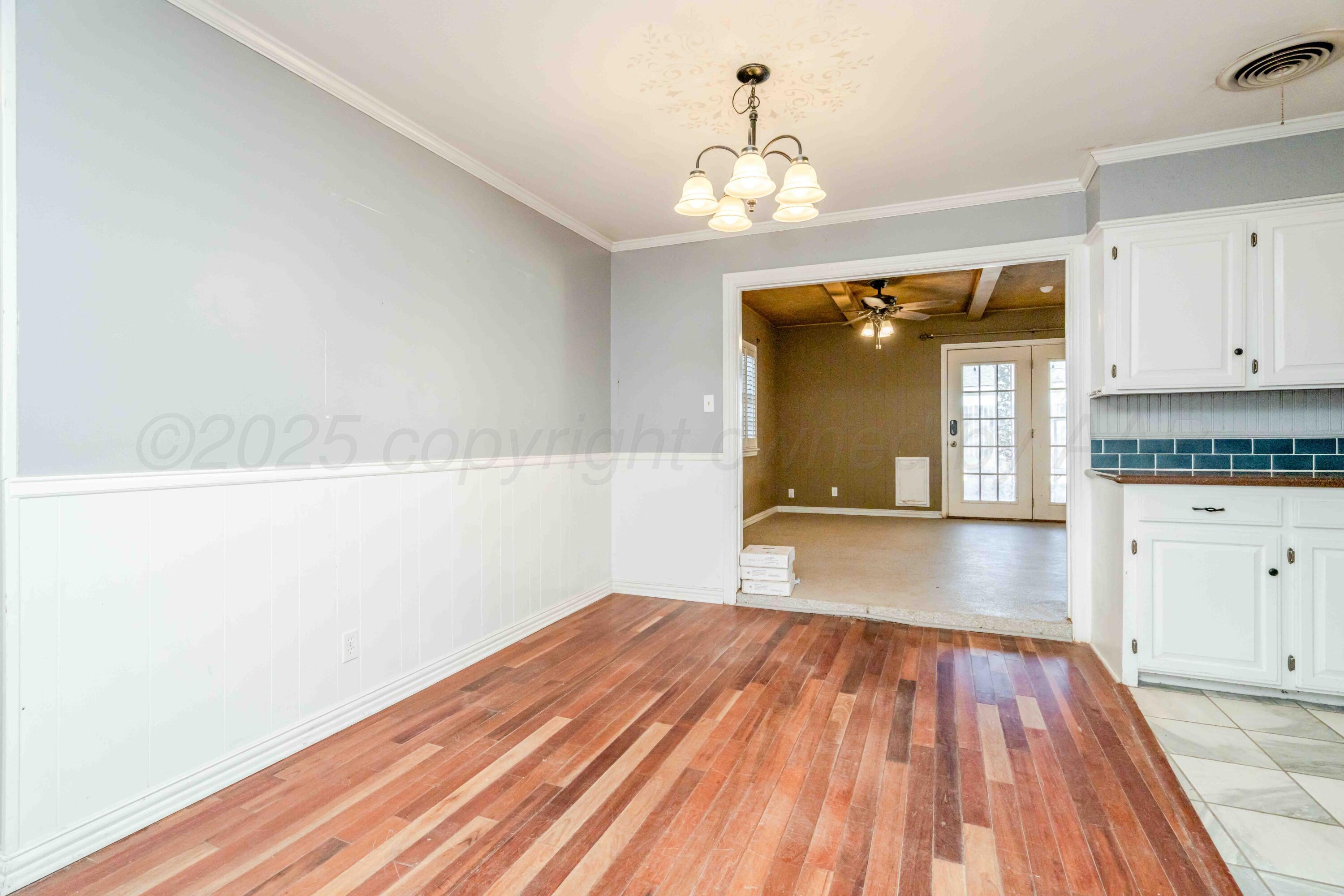 39 Crockett Drive Tulia, TX 79088 - Photo 8 of 29 a view of a room with wooden floor and cabinets