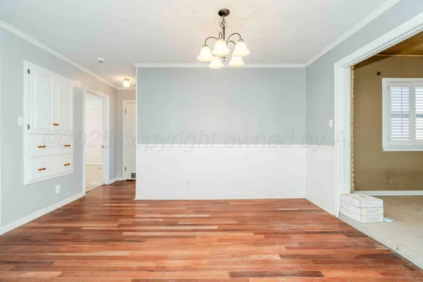 a view of a room with wooden floor and cabinet