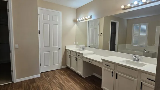 a bathroom with a double vanity sink and mirror