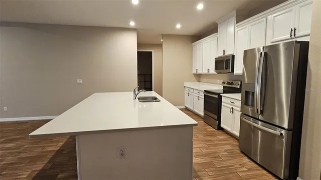 a kitchen with stainless steel appliances a refrigerator and a stove