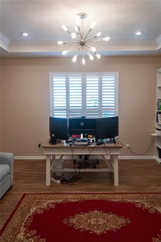 a kitchen with a stove a faucet and a coffee table