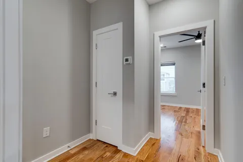 a view of bedroom with a bed and wooden floor