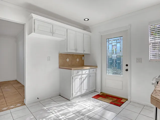 a living room with washing machine and cabinets