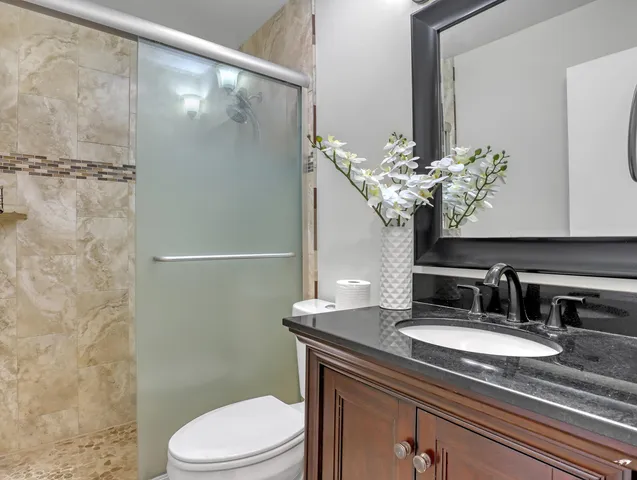 an empty room with a window and a ceiling fan