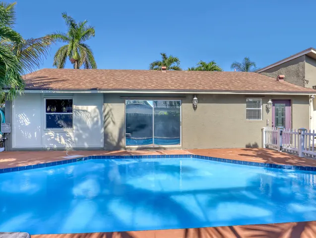 a view of a swimming pool with an outdoor seating