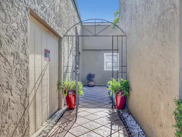 a potted plant sitting in front of a brick house
