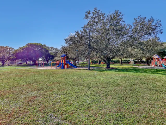 a view of a house with a yard and a garden