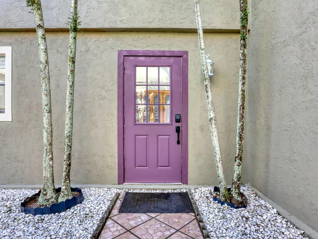 a view of a hallway with wooden floor and a cabinet
