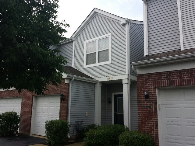 4561 Garritano Street, Unit B Yorkville, IL 60560 - Photo 1 of 11 a front view of a house with plants