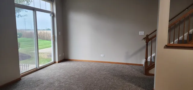 a view of an empty room with glass door