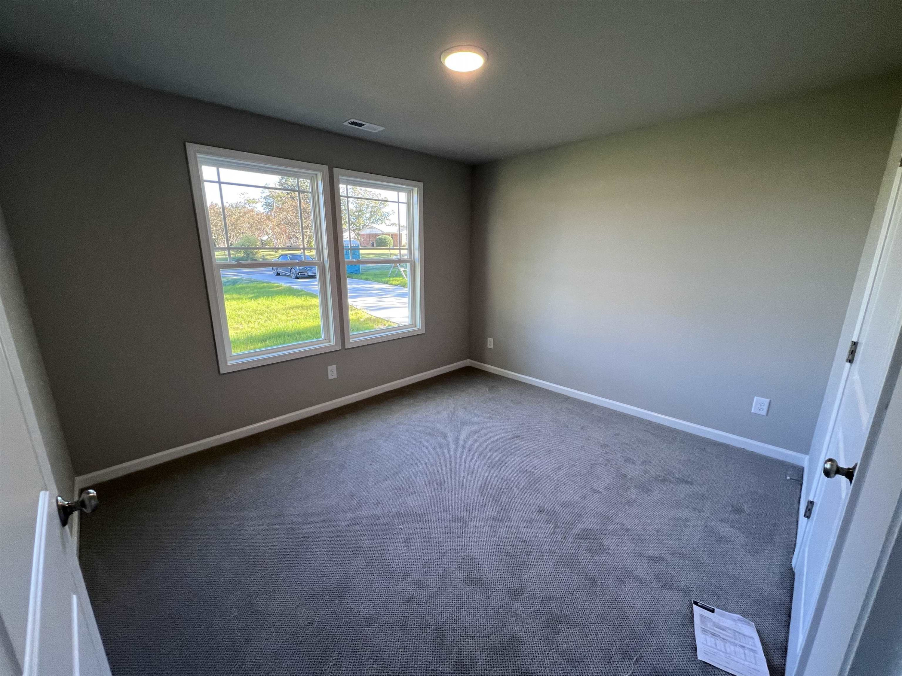 528 Roberts Road Willow Spring, NC 27592 - Photo 15 of 19 an empty room with windows