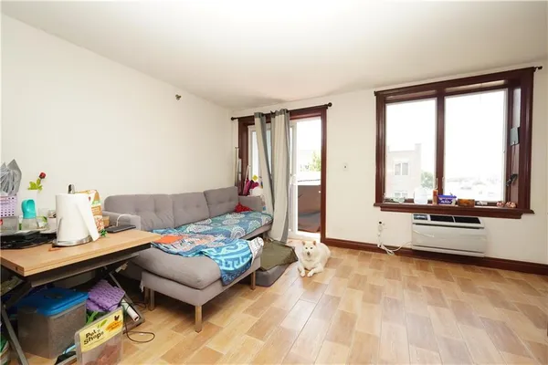 a bedroom with furniture and a large window