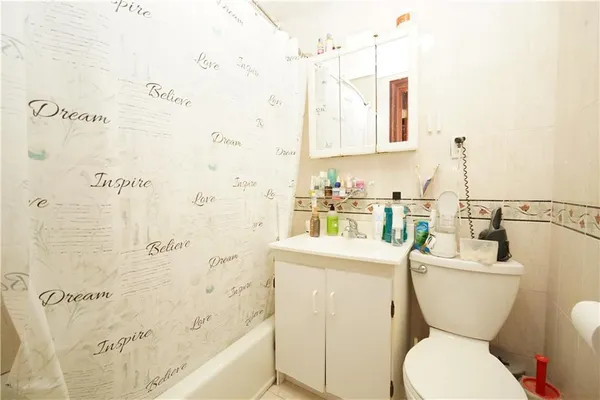 a white toilet sitting next to a bathroom sink