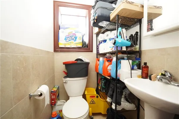 a bathroom with a toilet a sink and a shower curtain