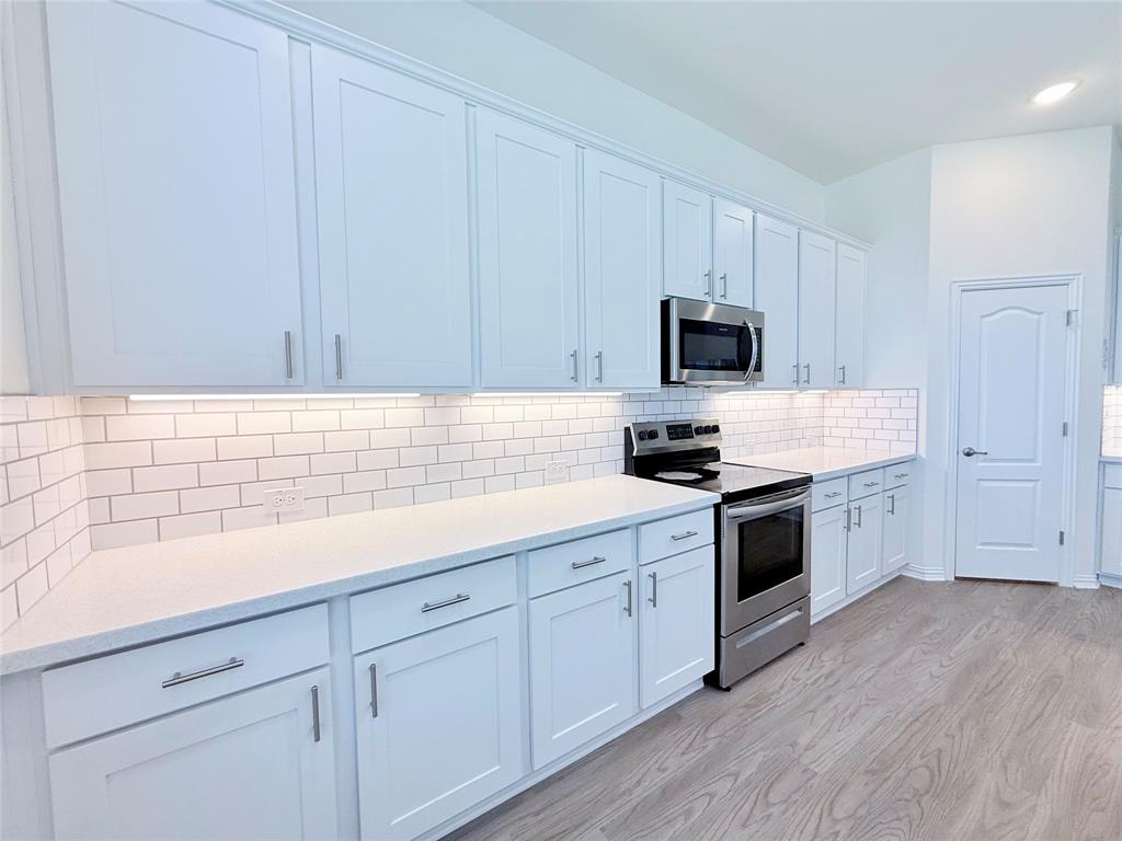 1336 Morning View Road Georgetown, TX 78628 - Photo 14 of 40 Culinary delights await in this bright kitchen with modern appliances and abundant white cabinetry.