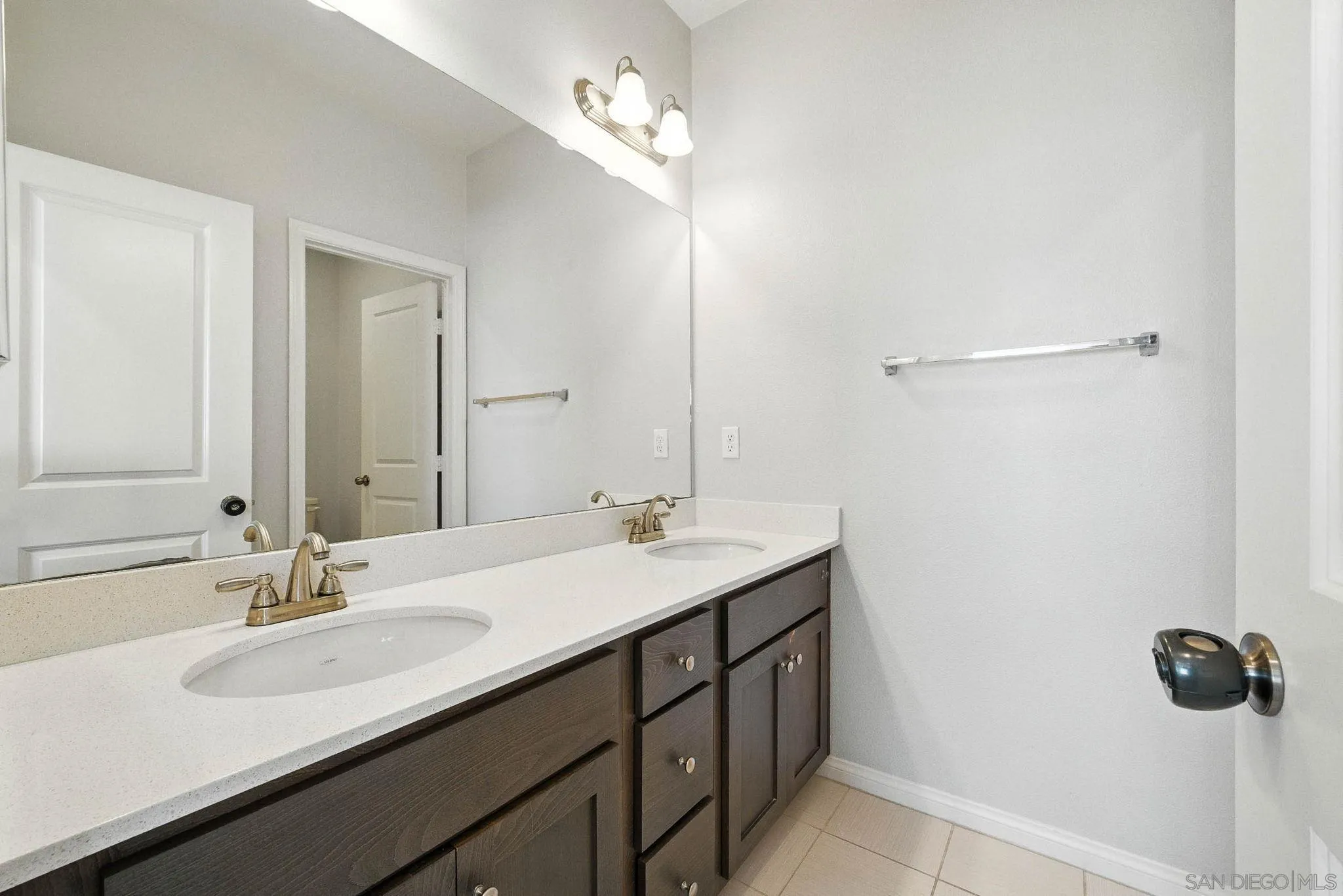 1319 Keck Road Chula Vista, CA 91913 - Photo 15 of 49 a bathroom with a double vanity sink a mirror and shower