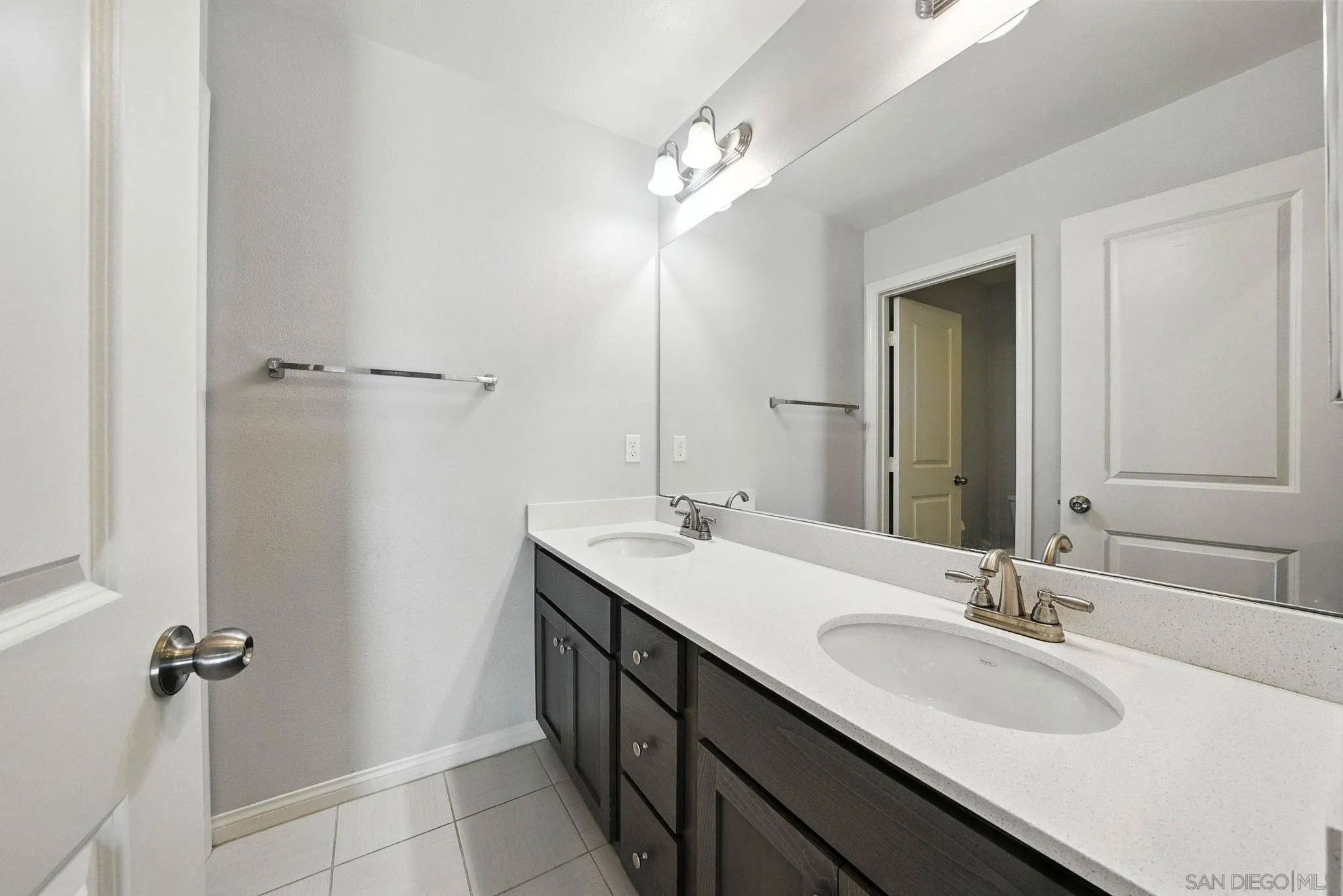 1319 Keck Road Chula Vista, CA 91913 - Photo 20 of 49 a bathroom with a double vanity sink a mirror and a shower