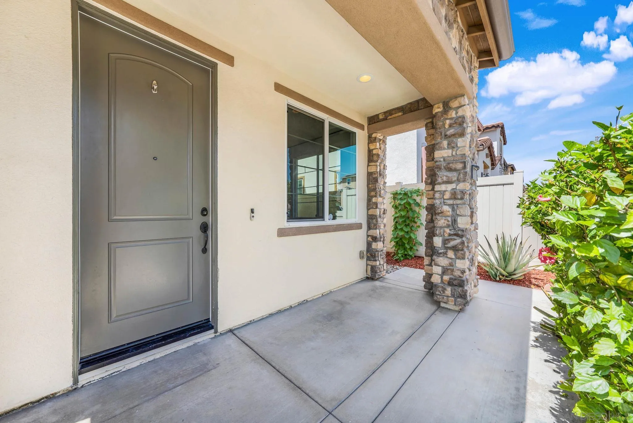 1319 Keck Road Chula Vista, CA 91913 - Photo 21 of 49 an empty room with potted plants in front of door