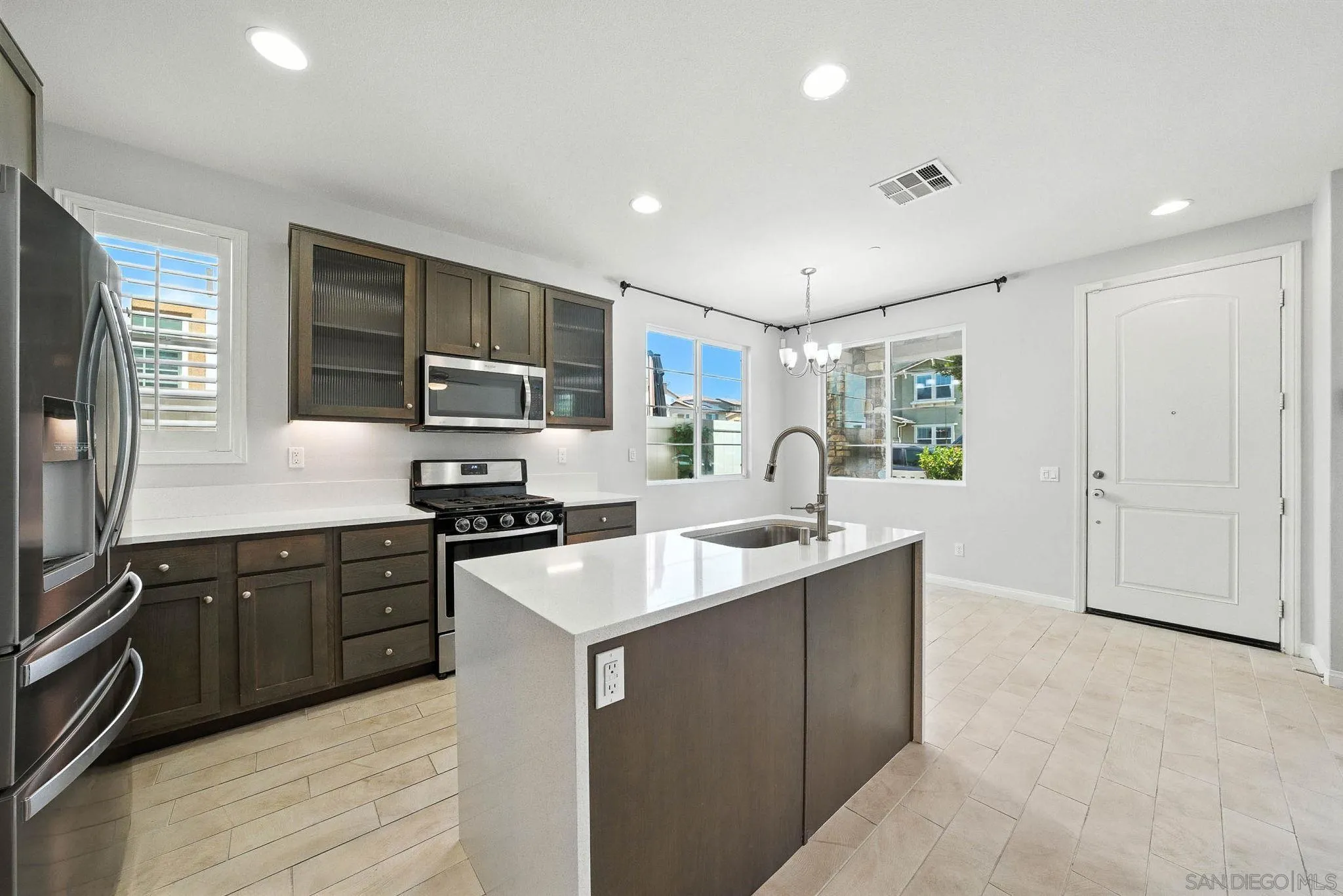 1319 Keck Road Chula Vista, CA 91913 - Photo 5 of 49 a kitchen with stainless steel appliances granite countertop a sink stove and refrigerator