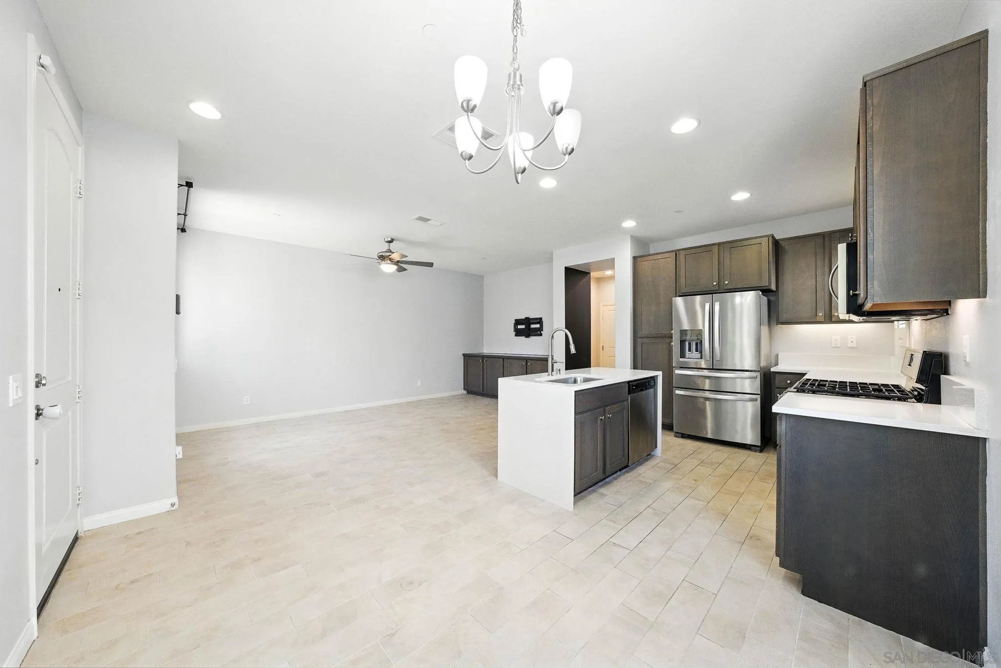 1319 Keck Road Chula Vista, CA 91913 - Photo 7 of 49 a large kitchen with kitchen island a large counter top space and stainless steel appliances