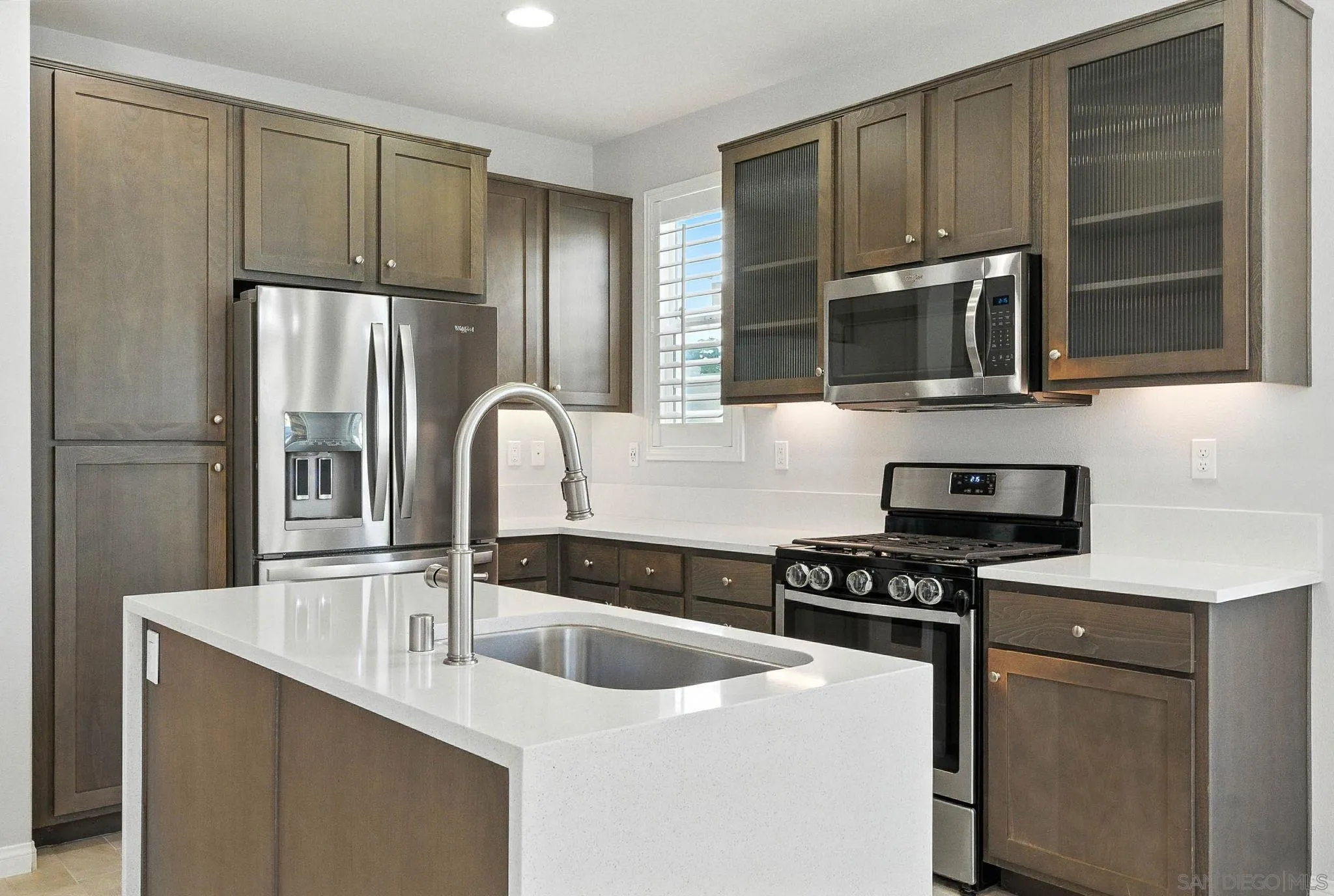 1319 Keck Road Chula Vista, CA 91913 - Photo 8 of 49 a kitchen with granite countertop stainless steel appliances a sink stove and refrigerator