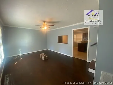 a view of an empty room and wooden floor