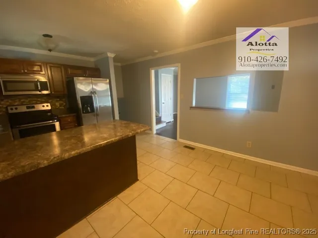 a kitchen with stainless steel appliances granite countertop a sink and cabinets