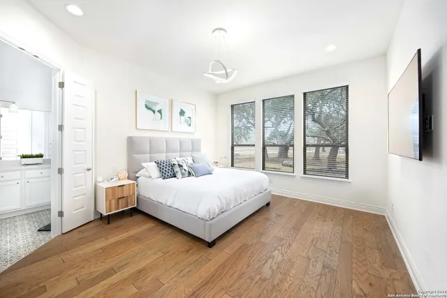 a spacious bedroom with a large bed and a large window