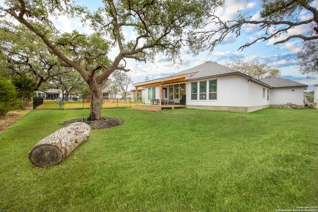 a view of a house with a backyard