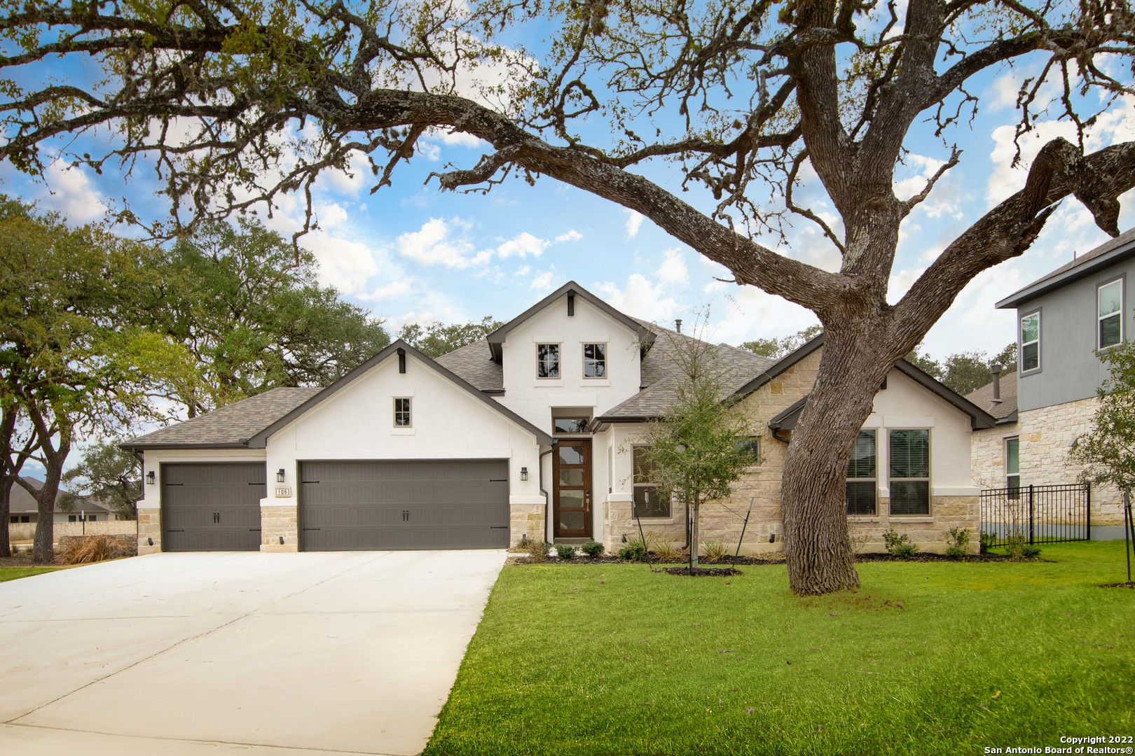 106 Milagro Boerne, TX 78006 - Photo 29 of 29 a front view of a house with a garden and yard