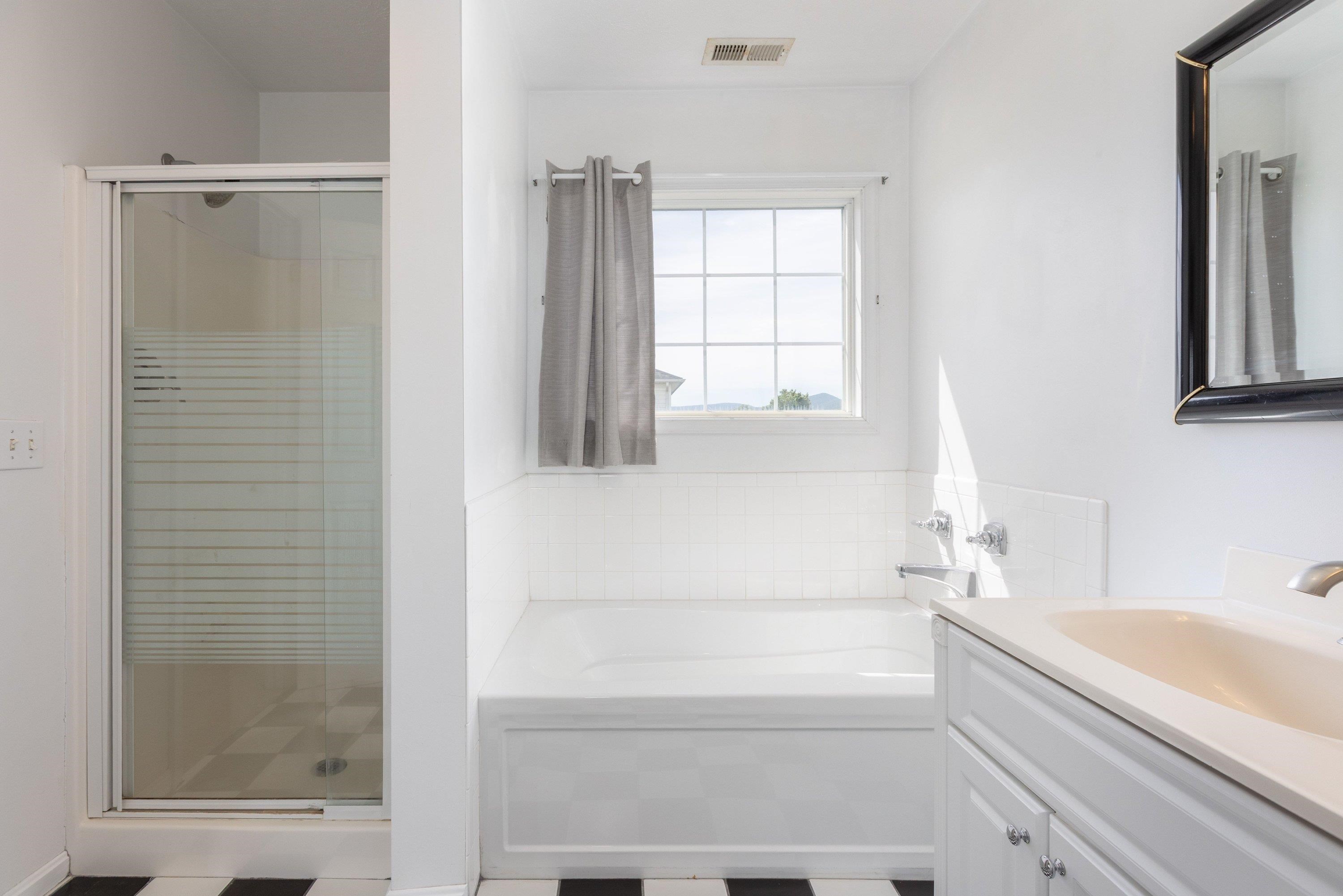 536 Three Leagues Road McGaheysville, VA 22840 - Photo 23 of 71 a bathroom with a bathtub and a shower