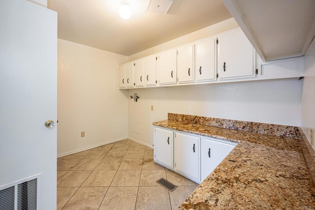 4650 Dulin Road, Unit 178 Fallbrook, CA 92003 - Photo 40 of 53 a kitchen with granite countertop white cabinets and a white stove