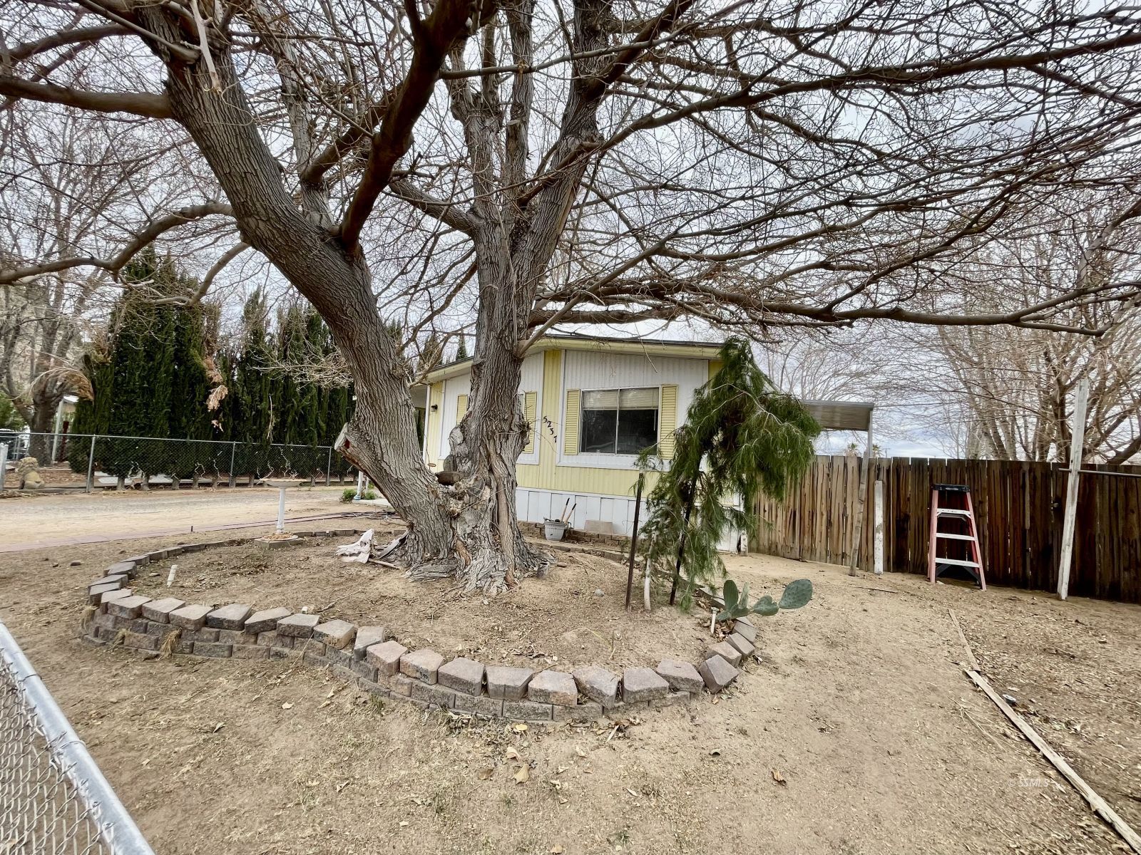 5237 Nolina Avenue Ridgecrest, CA 93555 - Photo 18 of 27 a view of a house with a yard covered in snow