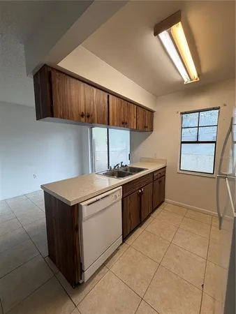 a kitchen with stainless steel appliances granite countertop a sink counter space cabinets and a window