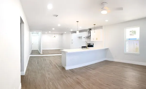 a view of kitchen with wooden floor and windows