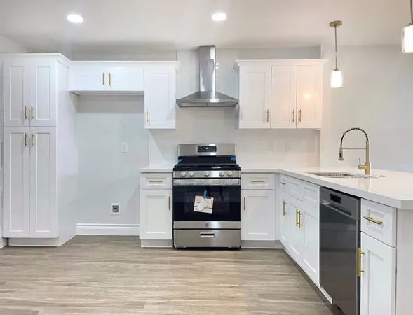 a kitchen with granite countertop a stove a sink and a refrigerator