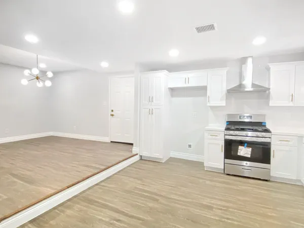 a view of kitchen with sink and wooden floor