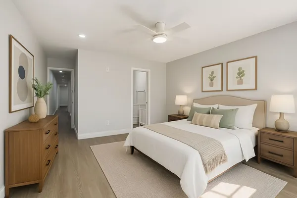 an empty room with wooden floor chandelier fan and windows