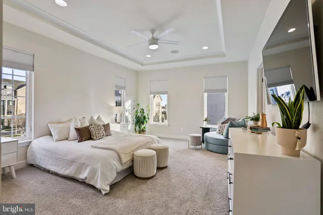 a bedroom with a bed couch and window