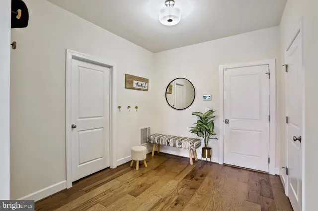 a living room with furniture and a mirror