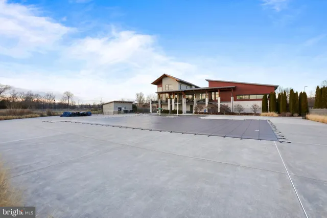 a front view of a house with a yard and lake view