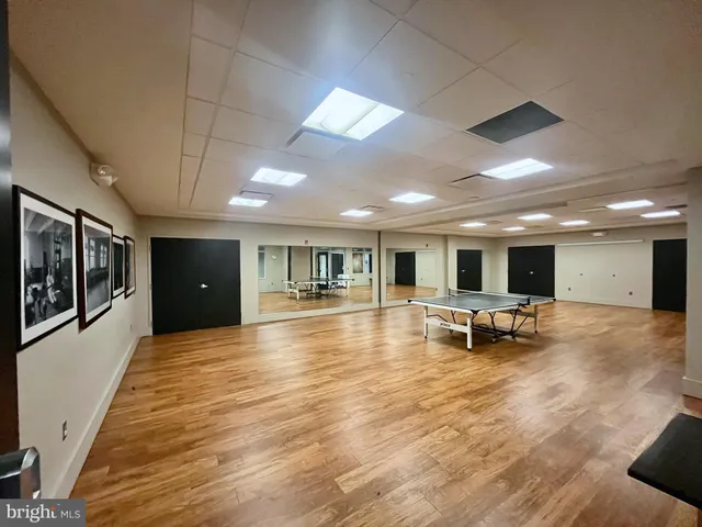 a view of a hall way with furniture and a flat screen tv