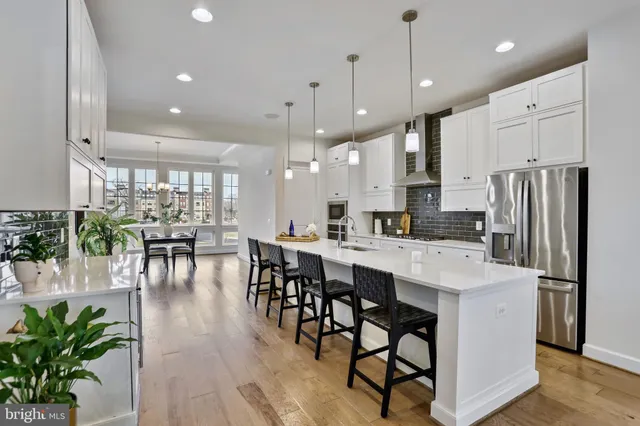a large kitchen with a table and chairs