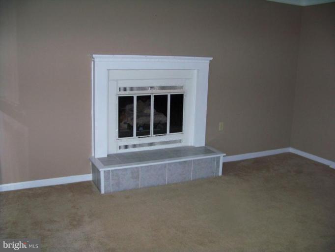 75 Cambridge Road Elkton, MD 21921 - Photo 5 of 7 a view of an empty room with a fireplace