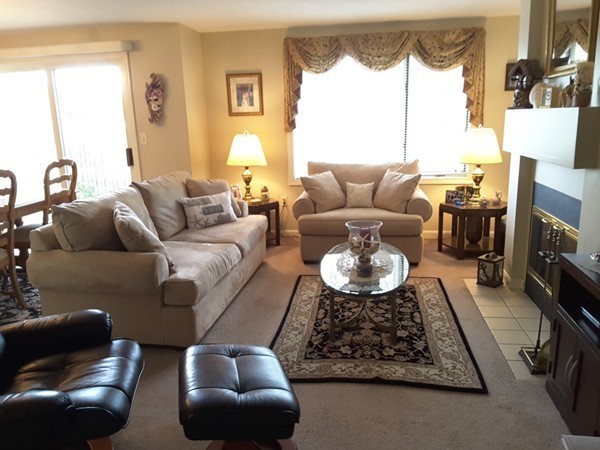 161 Stone Ridge Road, Unit 161 Franklin, MA 02038 - Photo 14 of 23 a living room with furniture and a floor to ceiling window