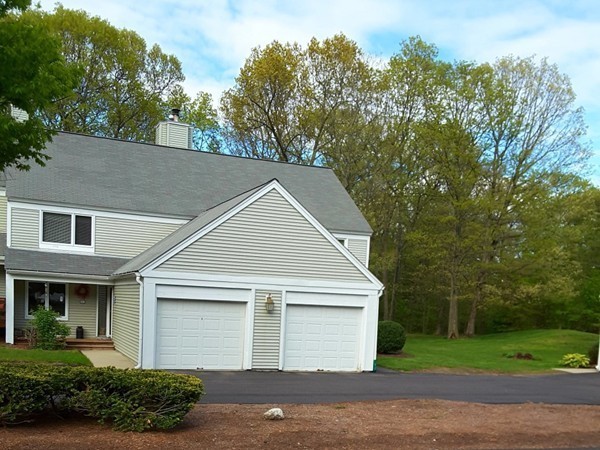 161 Stone Ridge Road, Unit 161 Franklin, MA 02038 - Photo 21 of 23 a front view of a house with a yard and garage