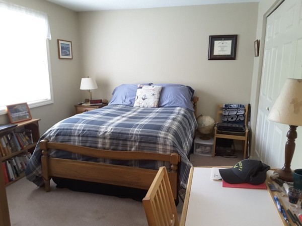 161 Stone Ridge Road, Unit 161 Franklin, MA 02038 - Photo 10 of 23 a bedroom with a bed and a tv on the dresser