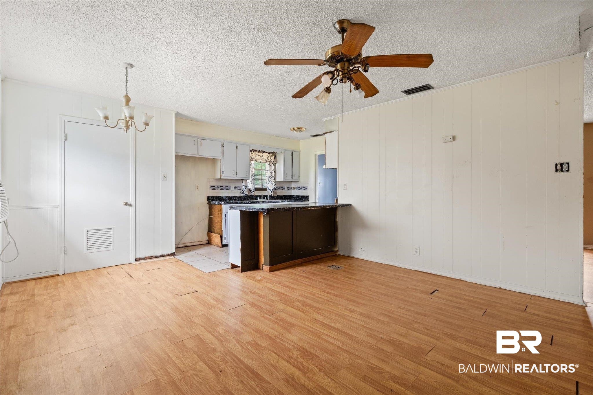 313 West 4th Avenue Foley, AL 36535 - Photo 7 of 20 Kitchen featuring white cabinetry, ceiling fan with notable chandelier, a textured ceiling, and light hardwood / wood-style flooring